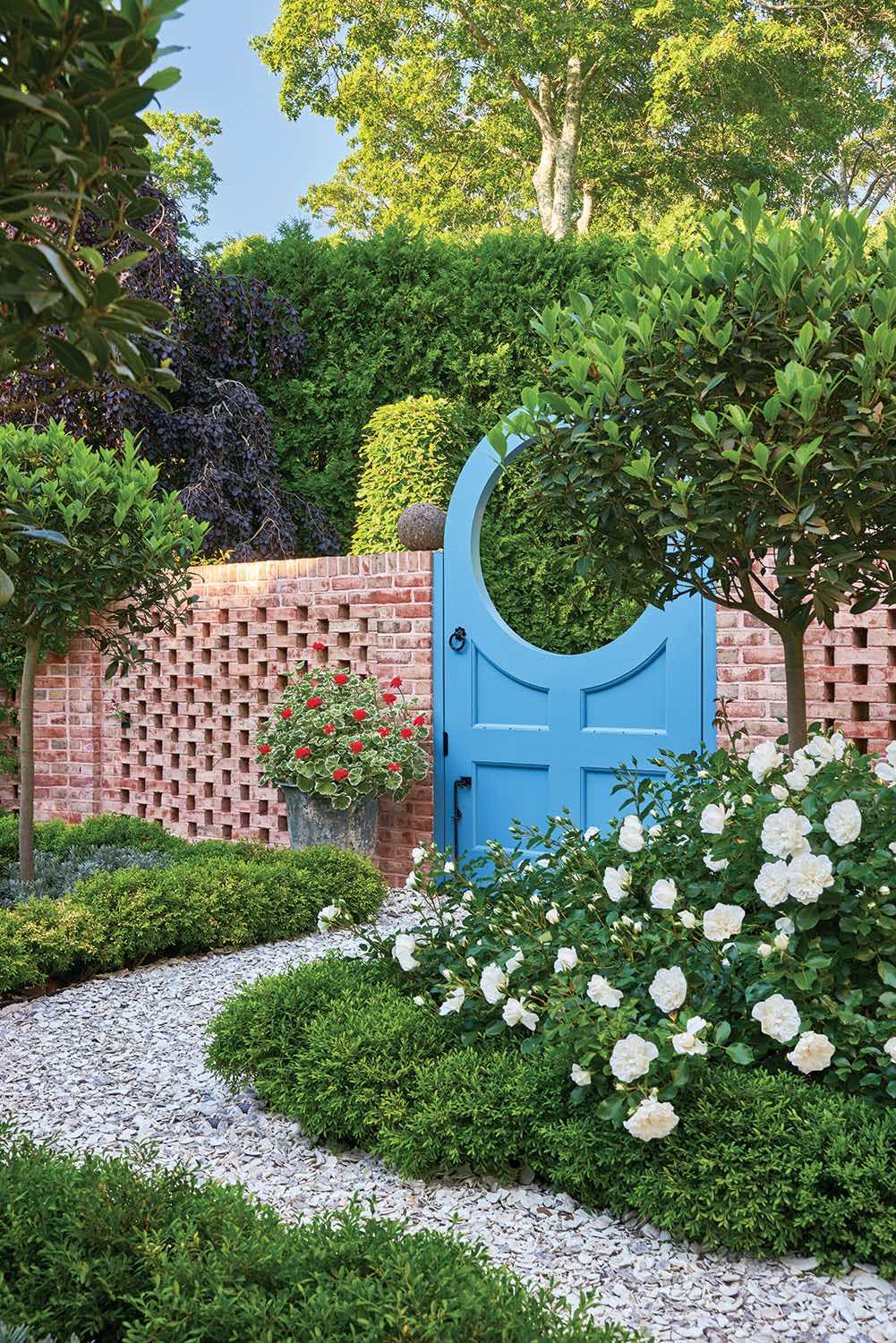 Hidcote Estate and Nancy Lancaster's Haseley Court, both in the English countryside, inspired the color of the moon gate in the kitchen garden.