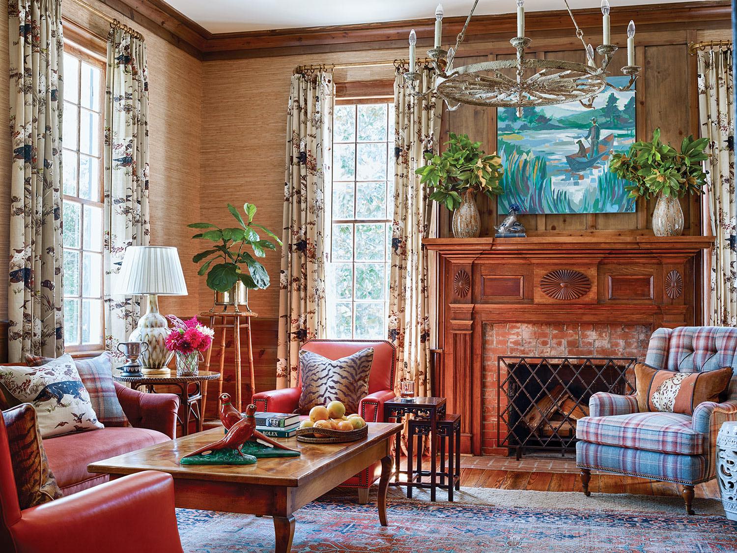 Study with layers of luxe fabrics that soften the paneled walls, millwork and the brick fireplace surround.