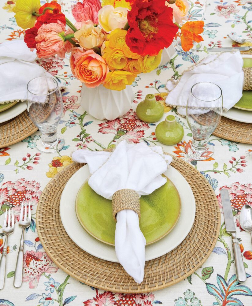 Alfresco table setting full of bright hues and beautiful blooms