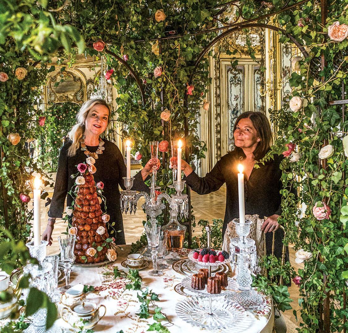 Laura Dowling with Parisian florist Anne Vitchen inside Vitchen's flower-covered, candlelit pavillion