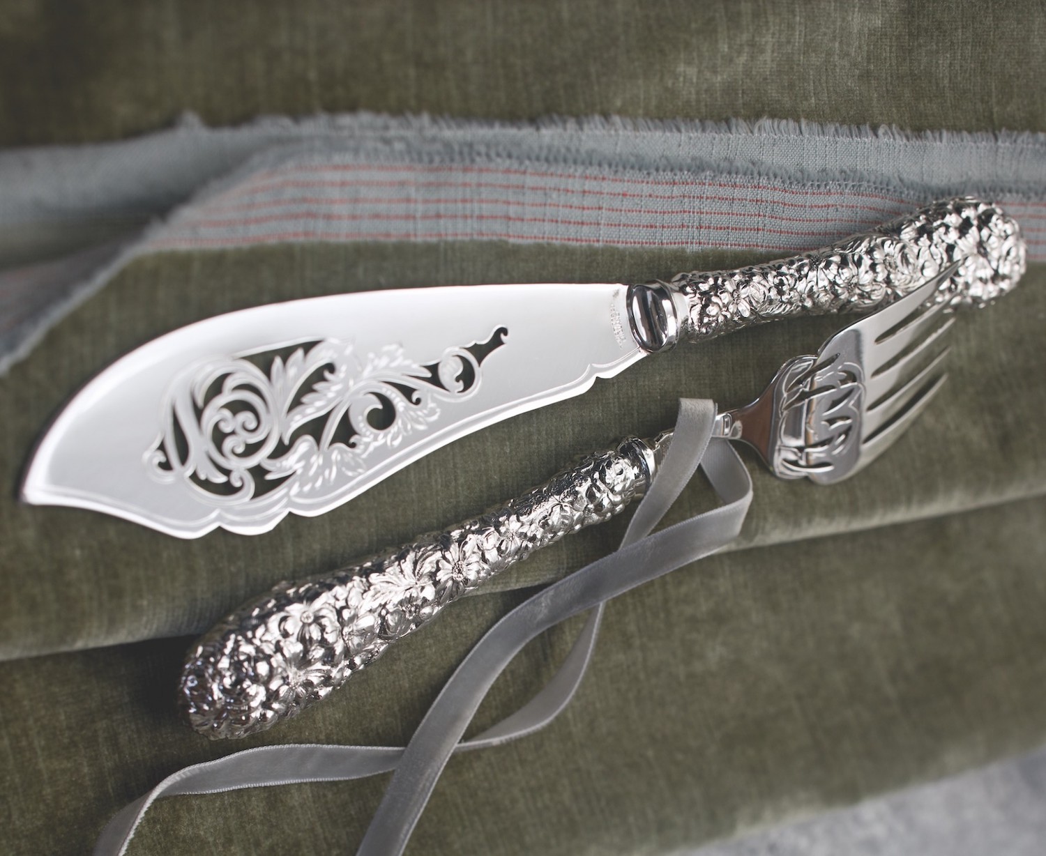 Repoussé flatware for serving fish shows of intricate pierced detailing on the blade and tines (Kirk Stieff).