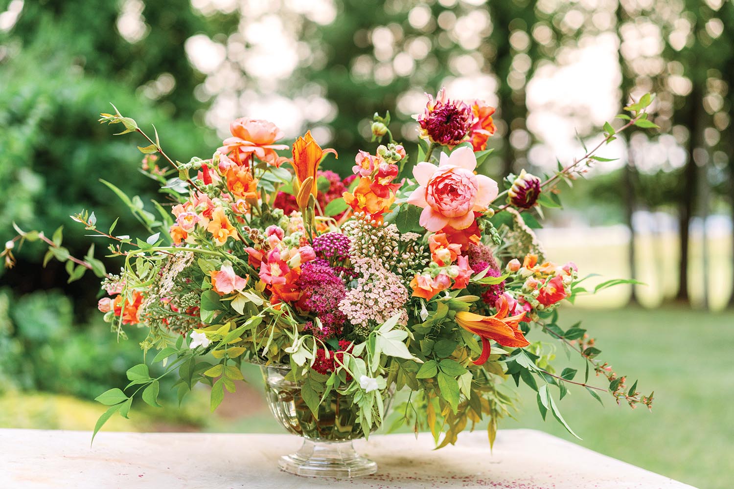 A bouquet of mixed flowers ranging from orange to pink to purple.