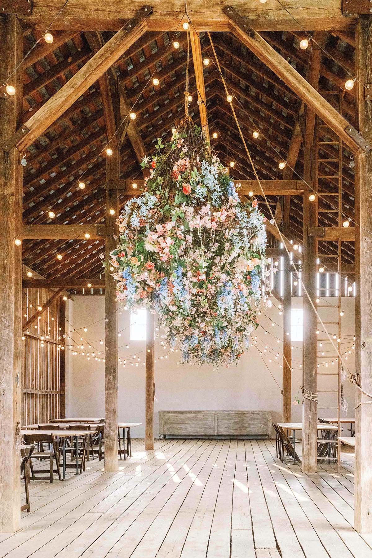 A floral arrangement hangs from the chandelier.