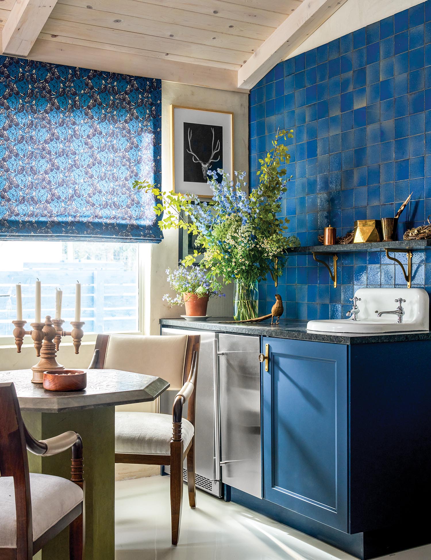 A guest-house wet bar area has blue tile and cabinetry.