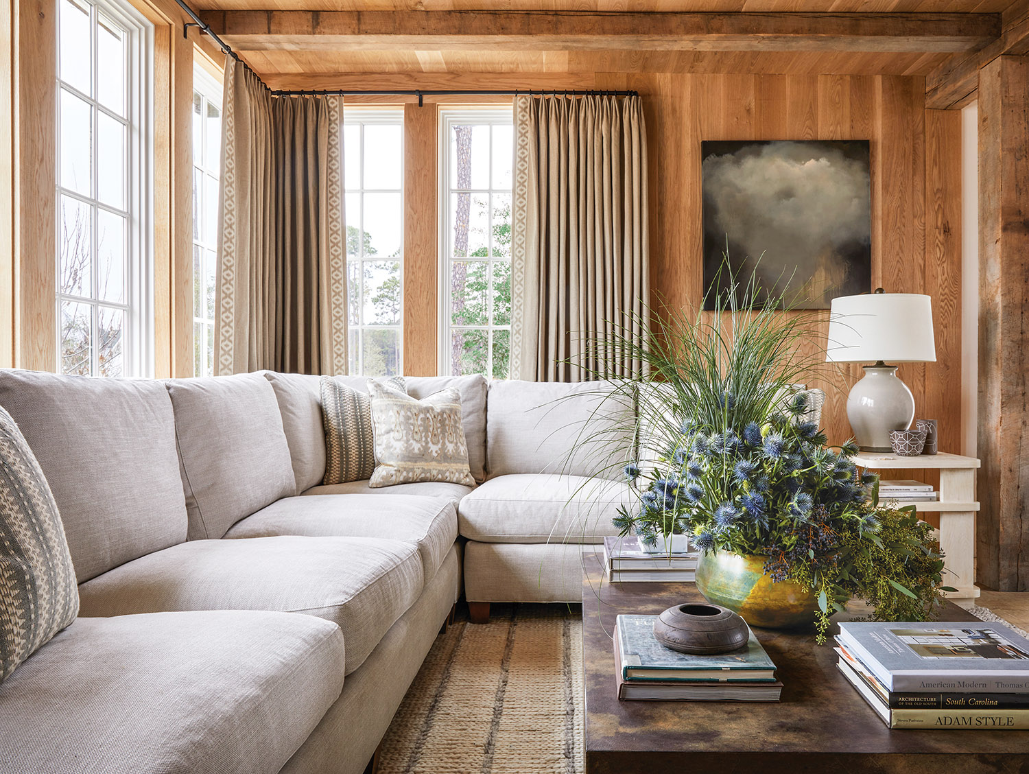 Sectional sofa with linen upholstery in wood-paneled den