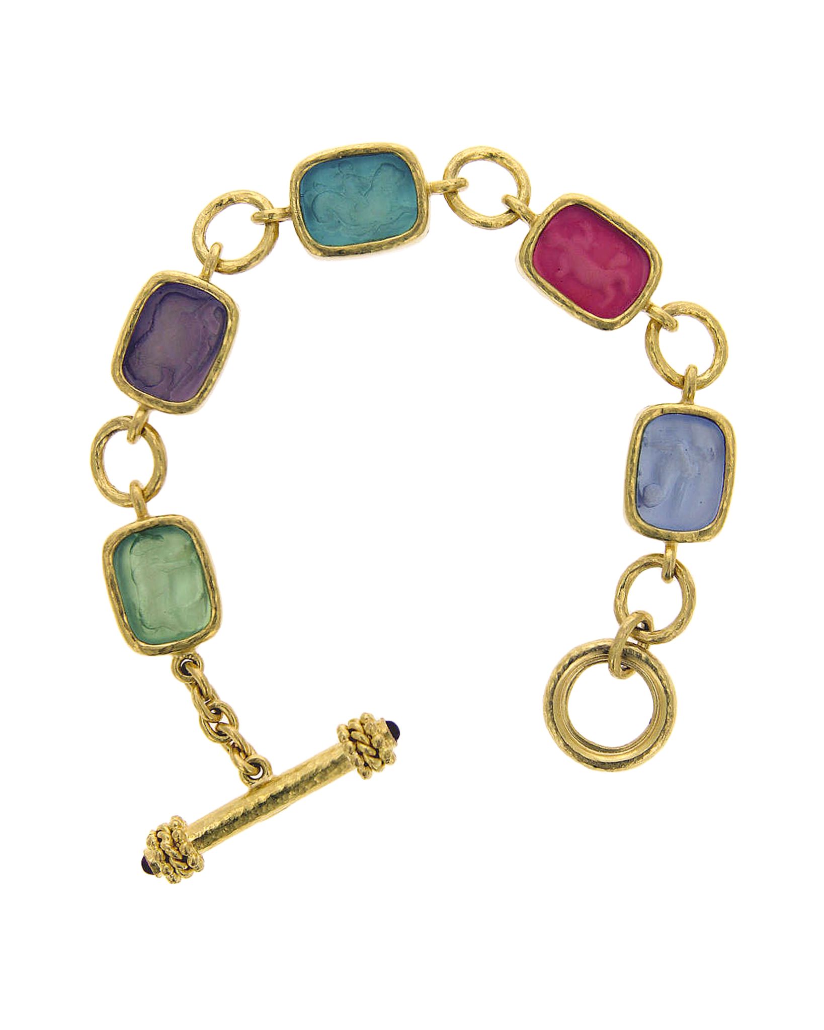 Multi-colored jewels on a gold bracelet.