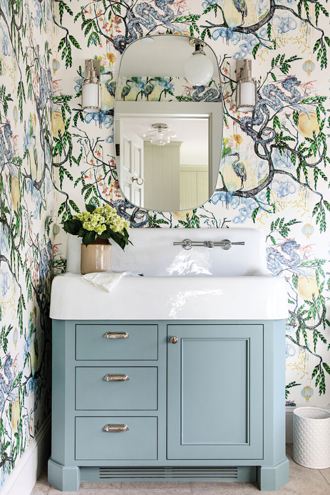 A bathroom wrapped in the pattern Good Fortune wallpaper is both elegant and playful.