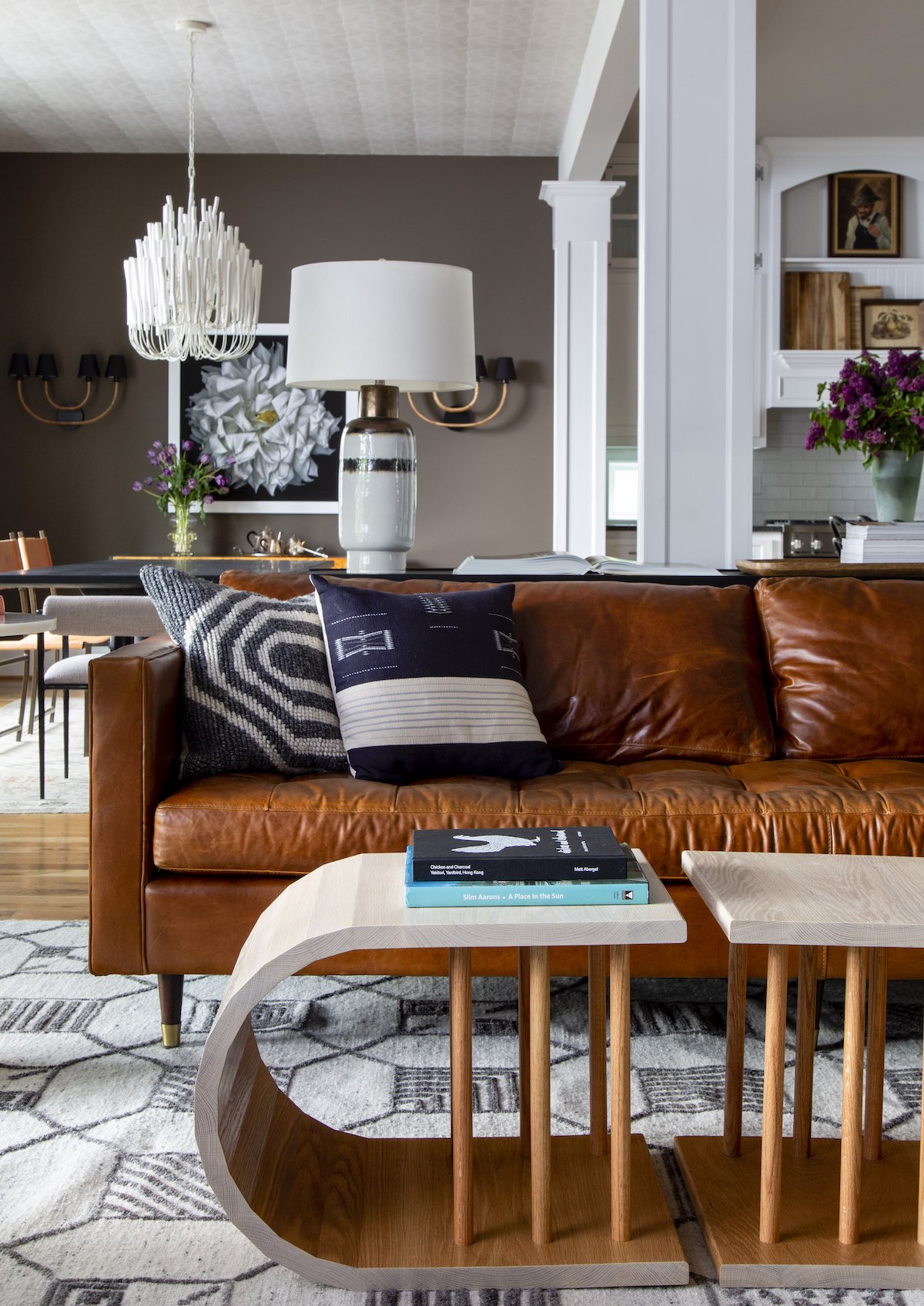 A leather track arm sofa will never go out of style and will only get better with age. “In summer with the air conditioning blowing, a leather sofa can feel a little cold so I always include a mix of pillows in fabrics like velvet,” says Tollett.