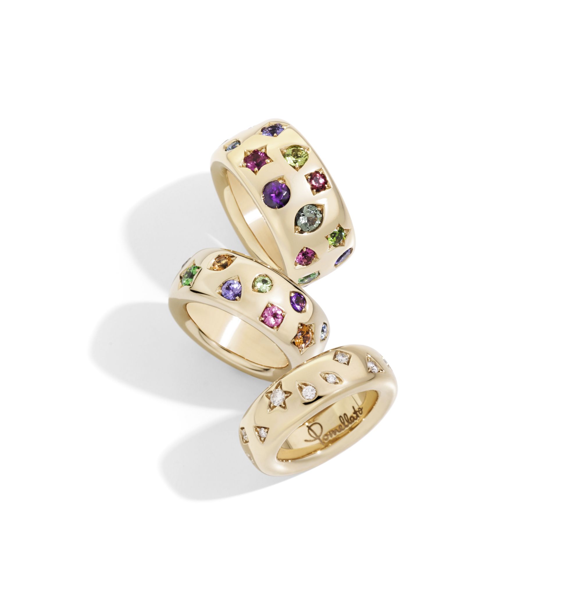 Gold rings with small multi-colored jewels.